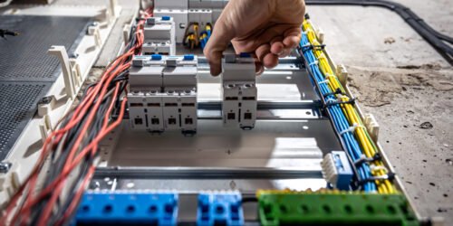 Voltage switchboard with circuit breakers are in the ON and OF positions in the big electric box for electrical distribution panel, and temporary electric cables are switched.